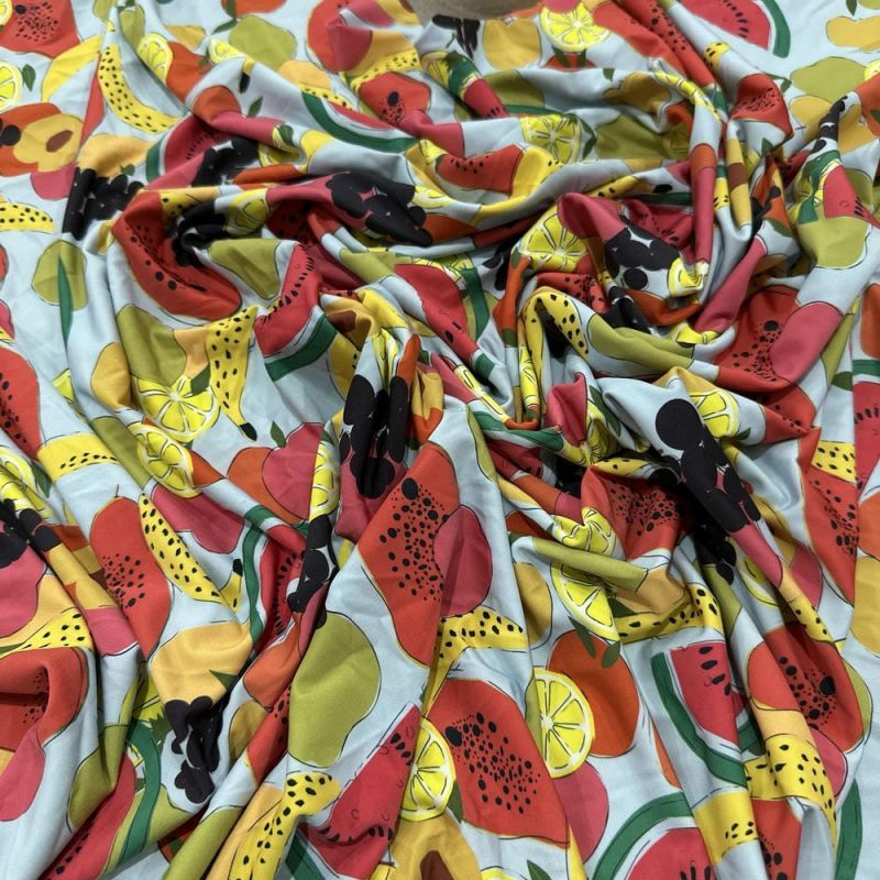 Tecido Malha Fluity Estampada Frutas Fundo Azul Claro • Luema Tecidos